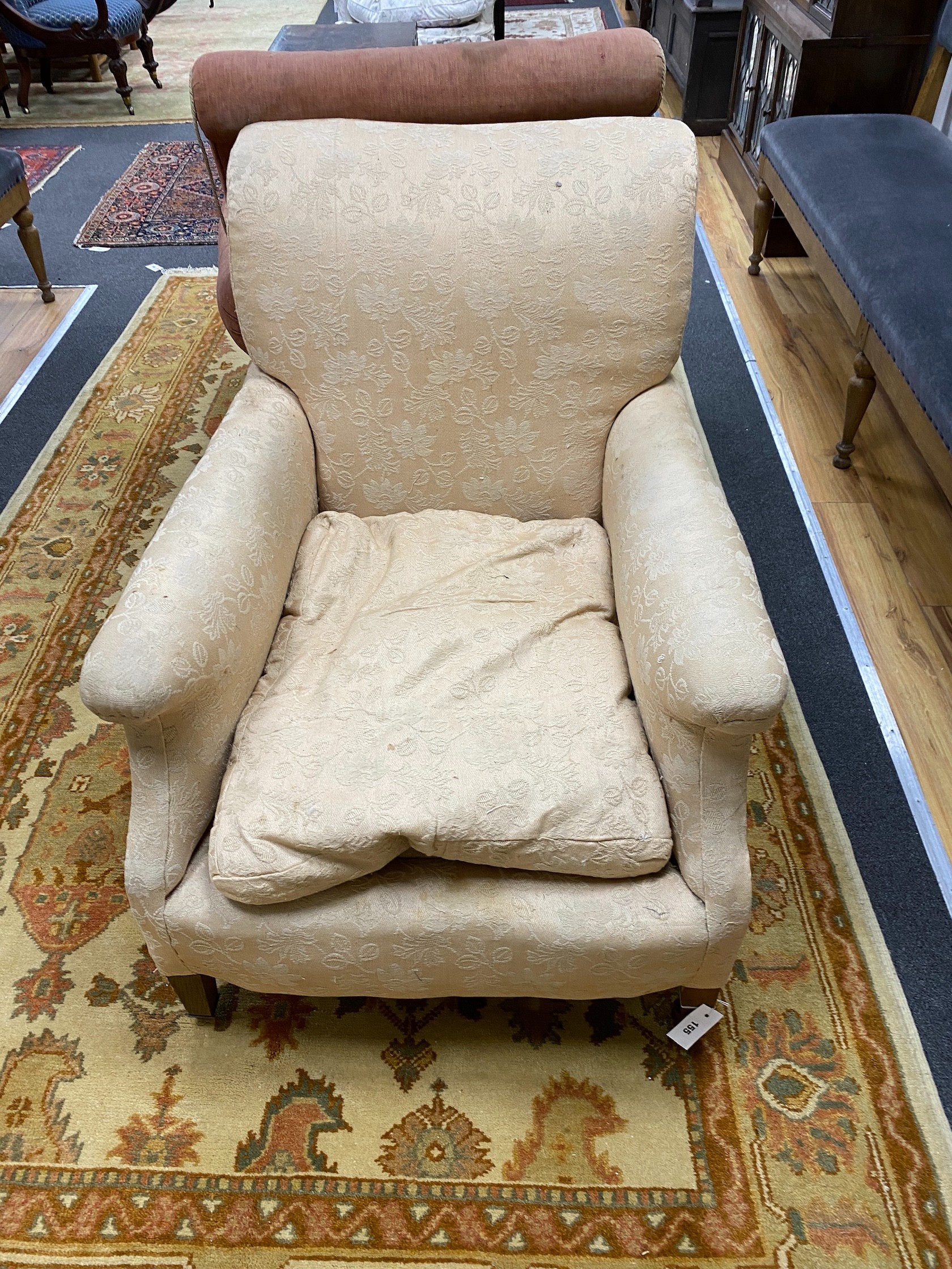 An Edwardian mahogany club armchair with squared tapered legs and brass castors, width 76cm, depth 100cm, height 88cm